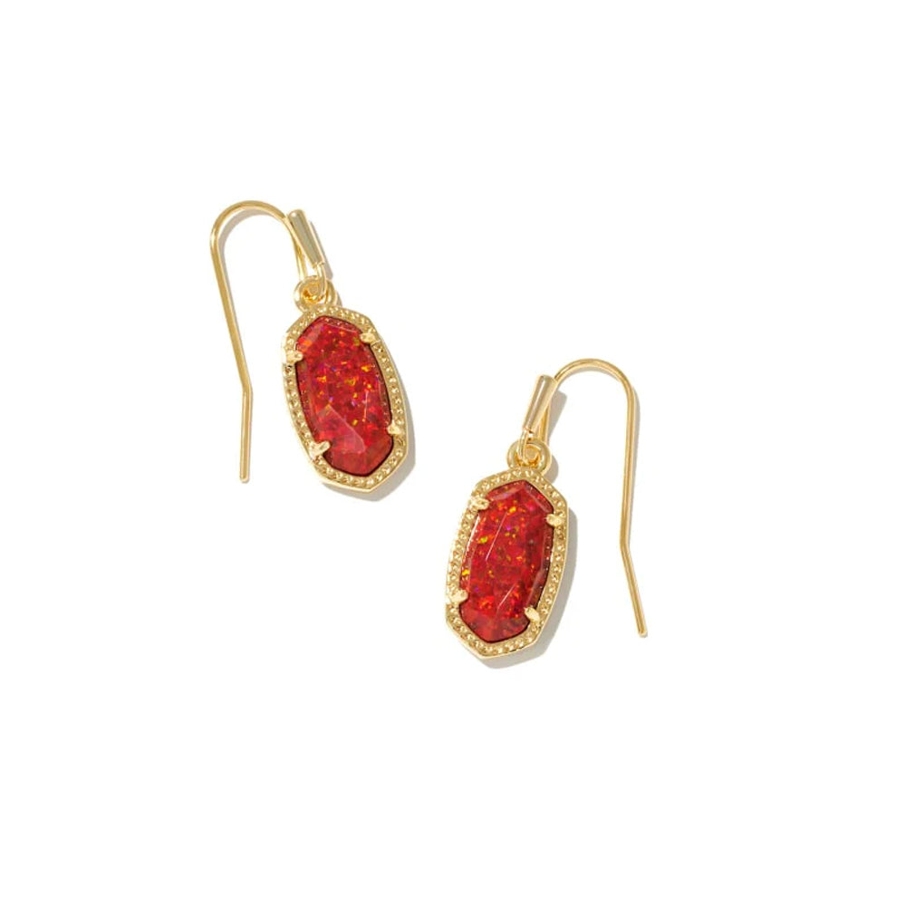 Gold earrings with red gemstones on a white background