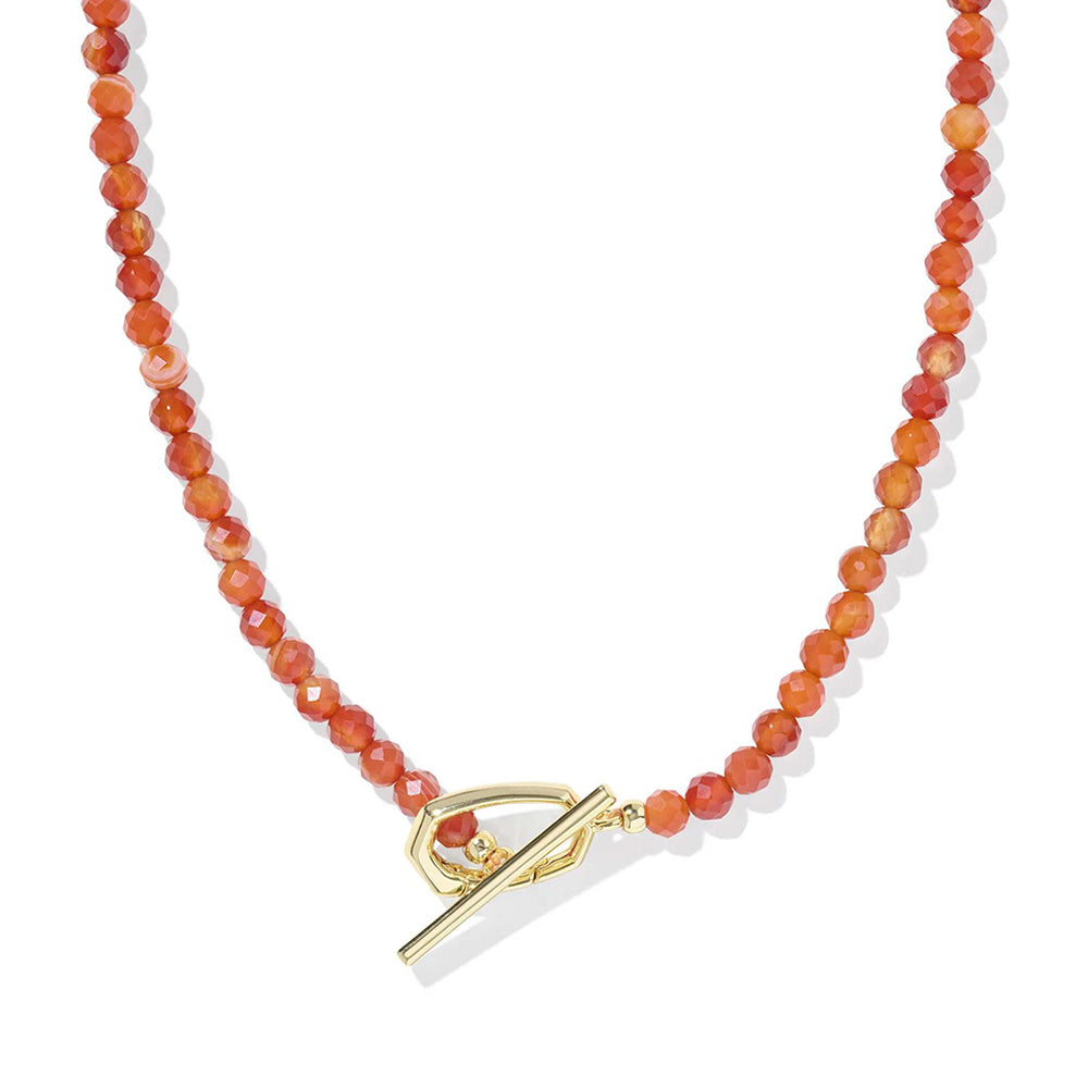 Necklace with orange beads and a gold and white clasp on a white background