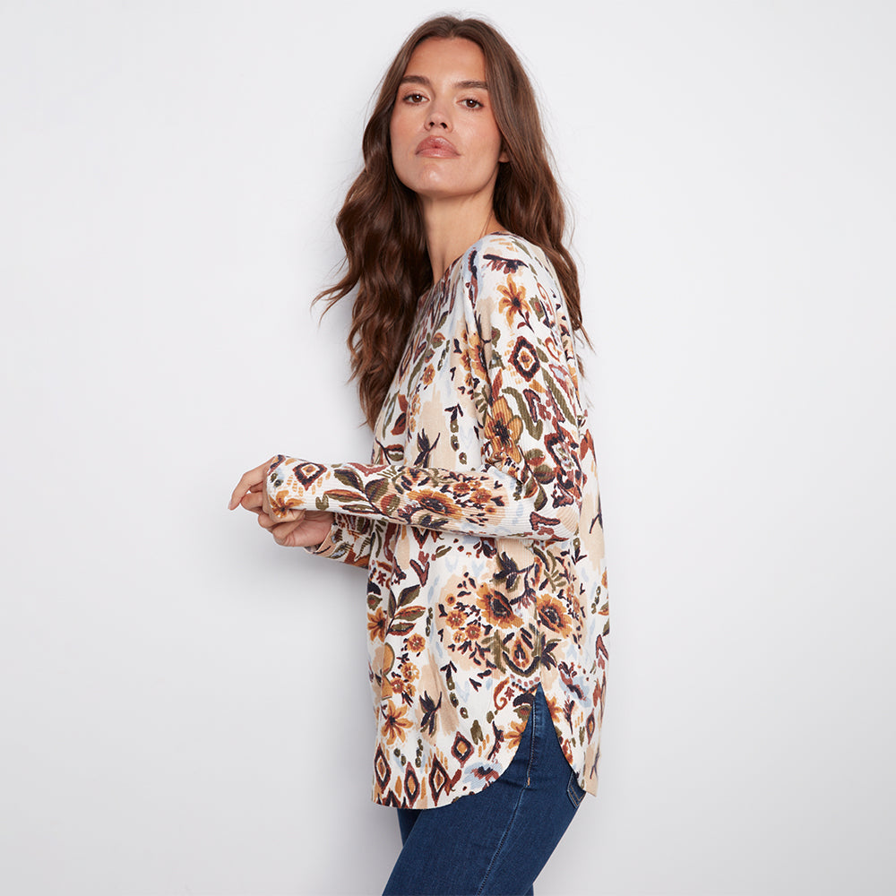 Woman wearing a floral blouse with a plain background