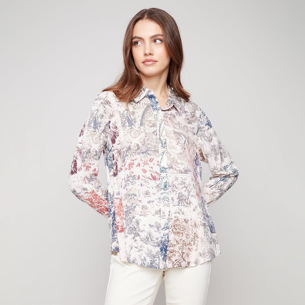 Woman wearing a floral blouse against a plain background
