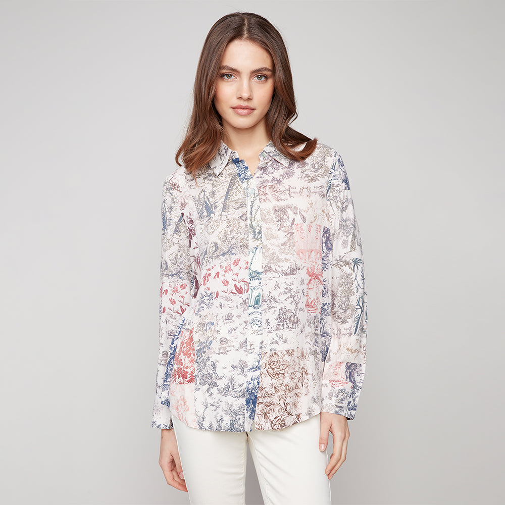 Woman wearing a floral blouse against a gray background