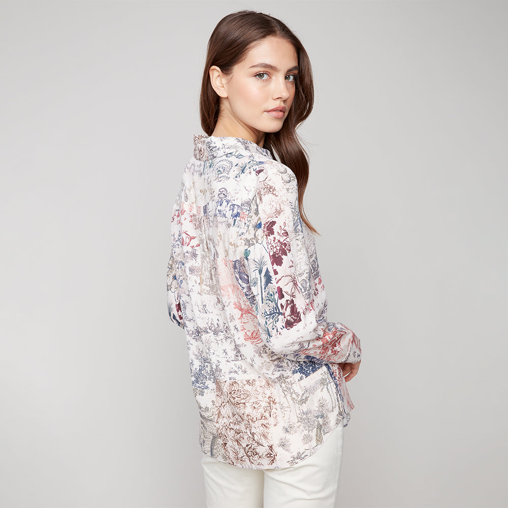 Woman wearing a floral blouse against a plain background