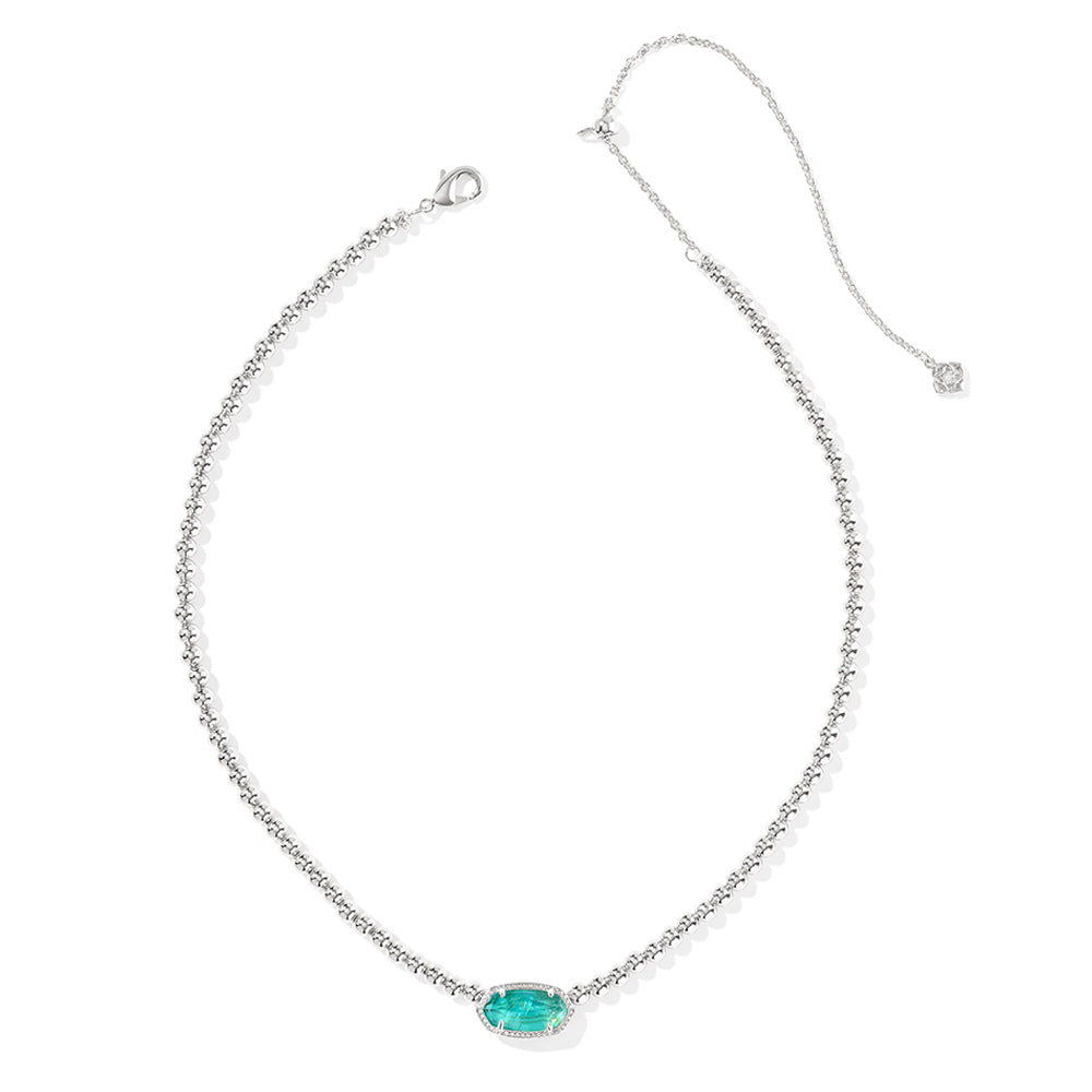 Silver necklace with a green gemstone pendant on a white background