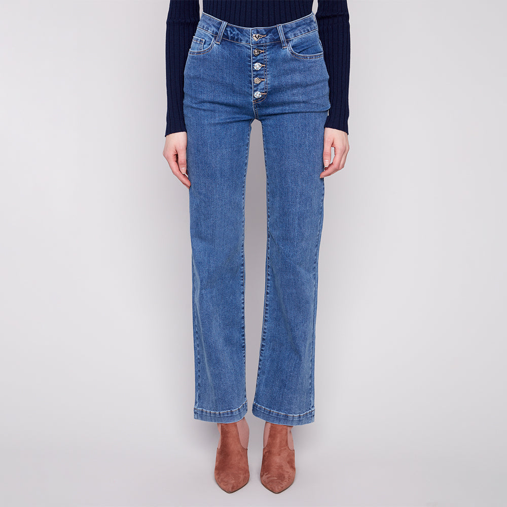 Blue jeans worn by a person on a white background