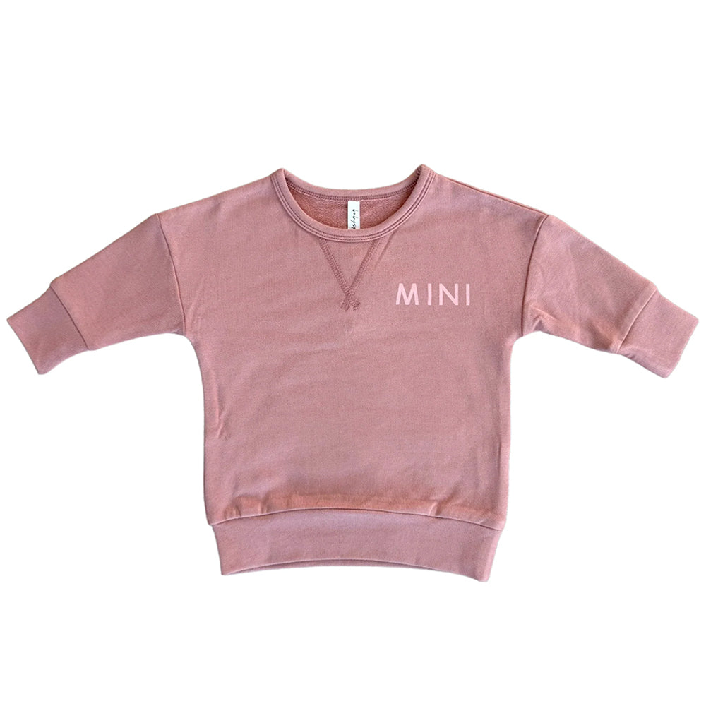 Pink sweatshirt with 'MINI' text on a white background