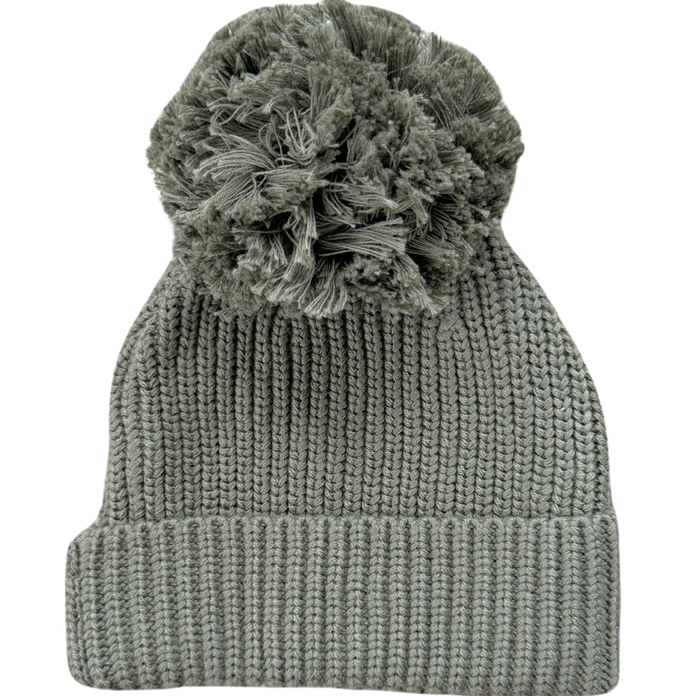 Green knit beanie with a textured pom-pom on a white background