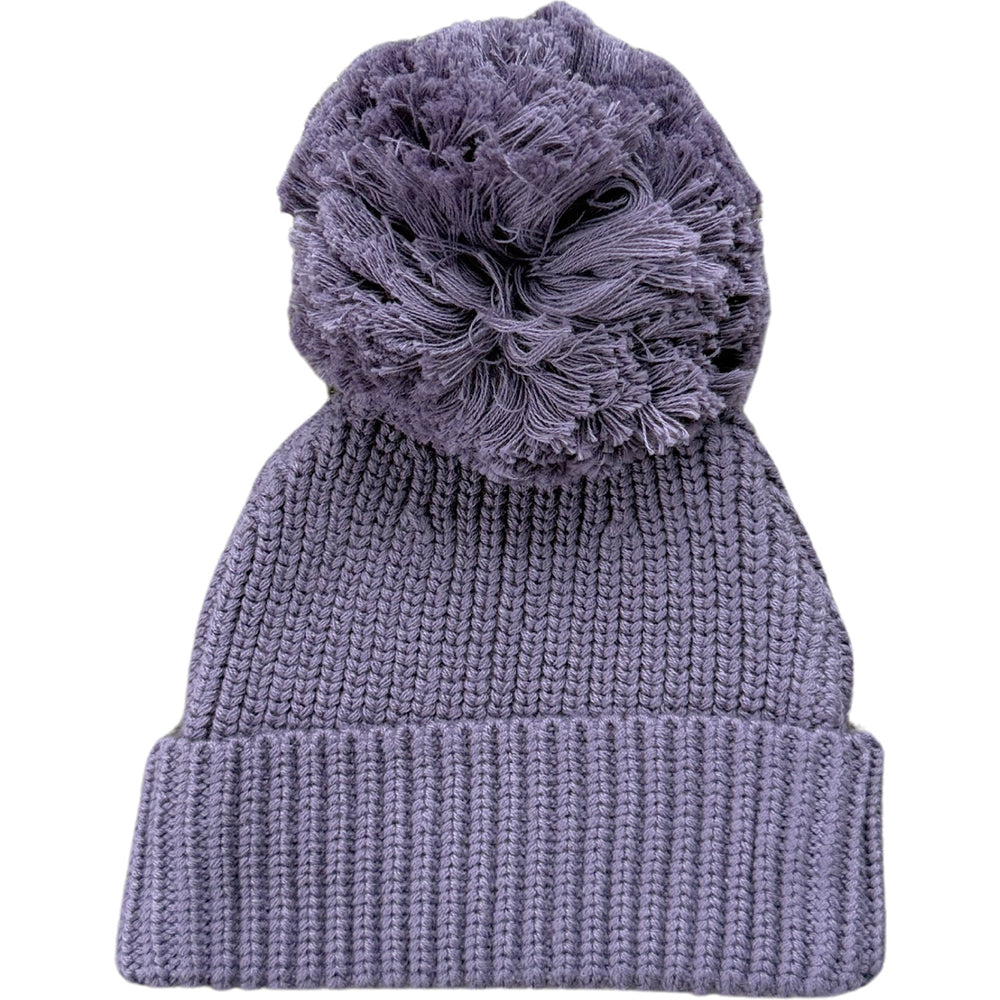 Knitted beanie with a large pom-pom on a white background