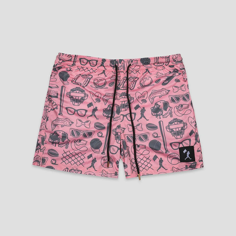 Pink shorts with a black graphic print of various icons like sunglasses, hats, and baseball bats, featuring a black drawstring and a small black brand patch on the lower left leg.
