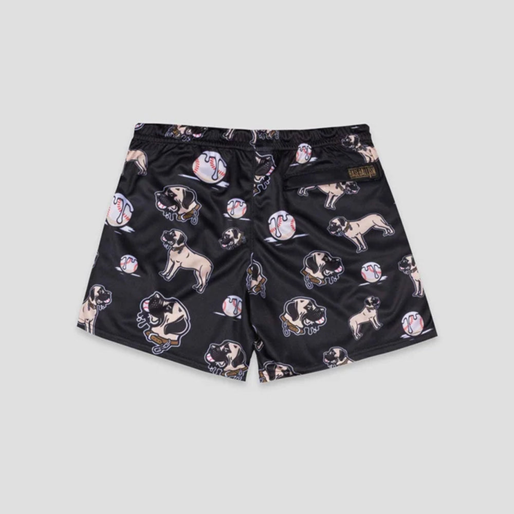 Black athletic shorts featuring an all-over print of pug dogs and baseballs, with a small brown brand patch on the right waistband, shown against a light gray background.
