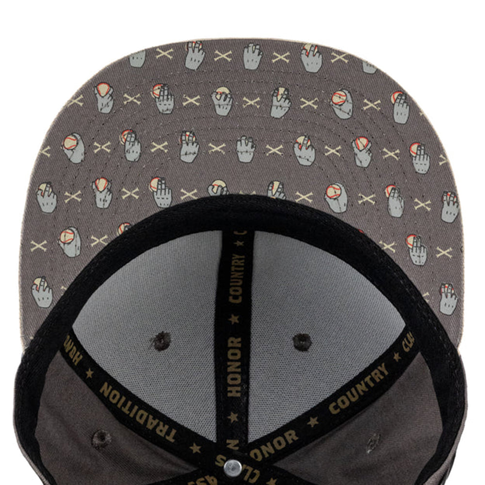 Close-up of the inside of a gray snapback cap with a repeating pattern of hand gestures and crossed X's, black mesh back panels, and black adjustable strap with gold text.
