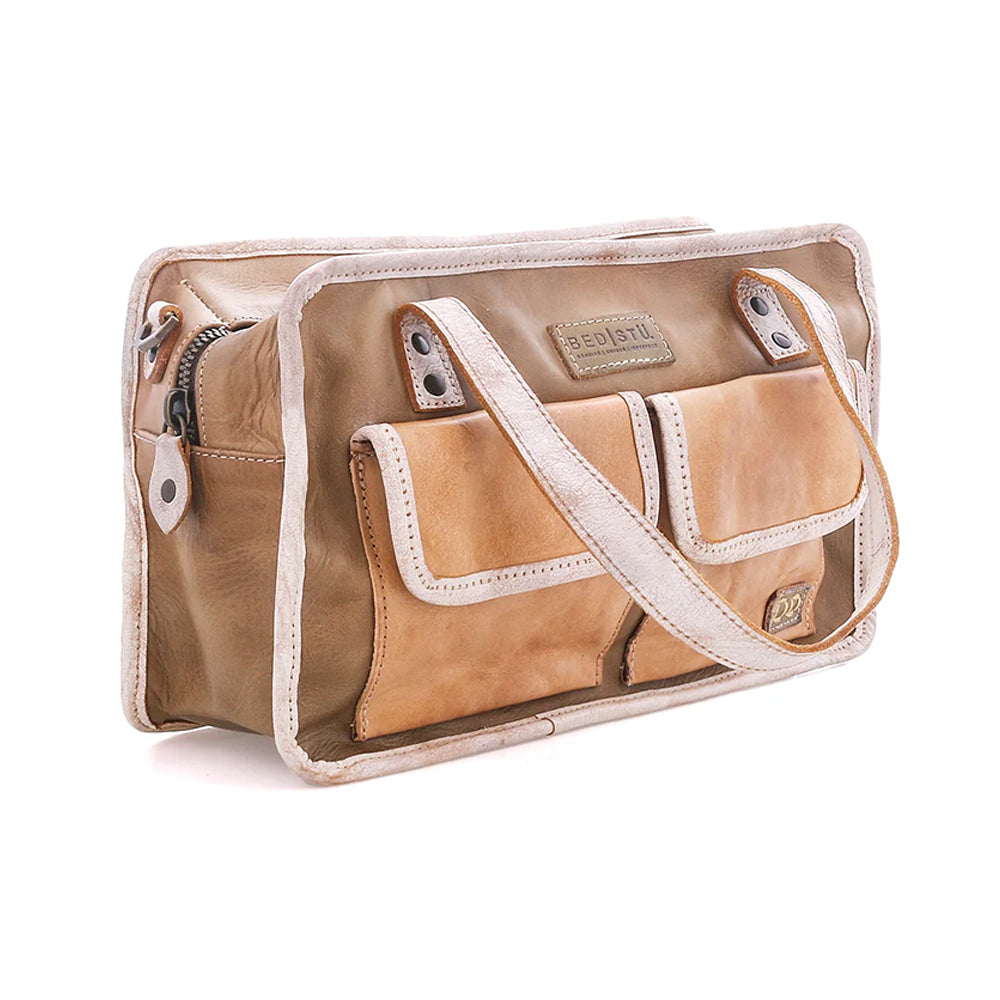 A tan leather messenger bag with cream-colored trim and a matching shoulder strap, shown on a plain white background. The bag features multiple front pockets and a zippered side pocket.