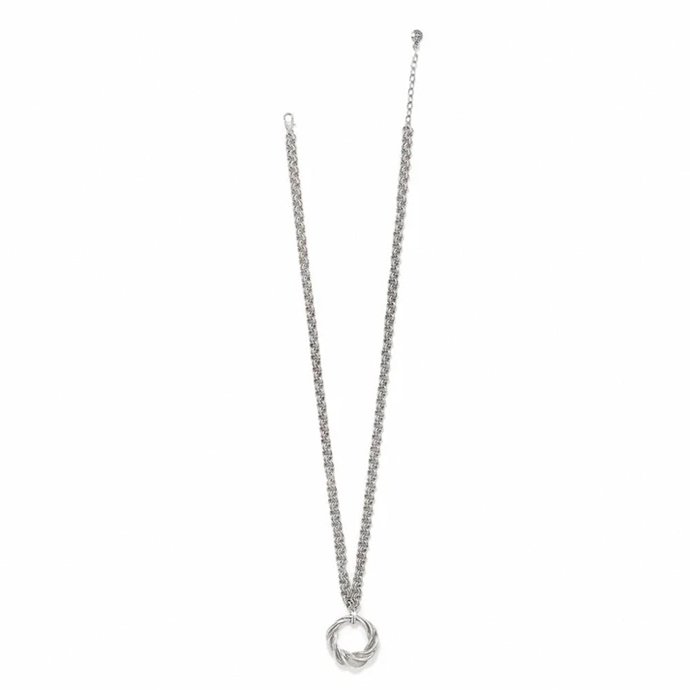 Silver necklace with a circular pendant on a white background