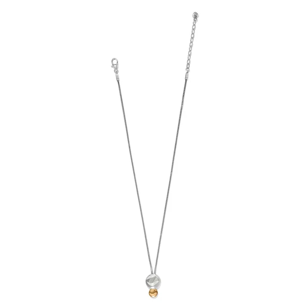 A delicate silver chain necklace featuring a double-circle pendant with a small gold bead at the bottom, displayed on a solid white background.