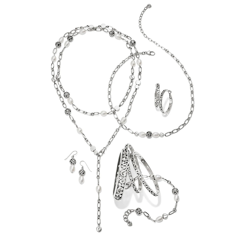 Silver jewelry set with necklace, earrings, and ring on a white background