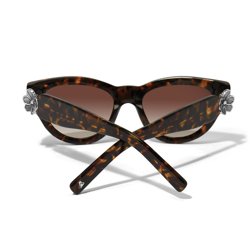 Tortoiseshell sunglasses with floral ends on a white background
