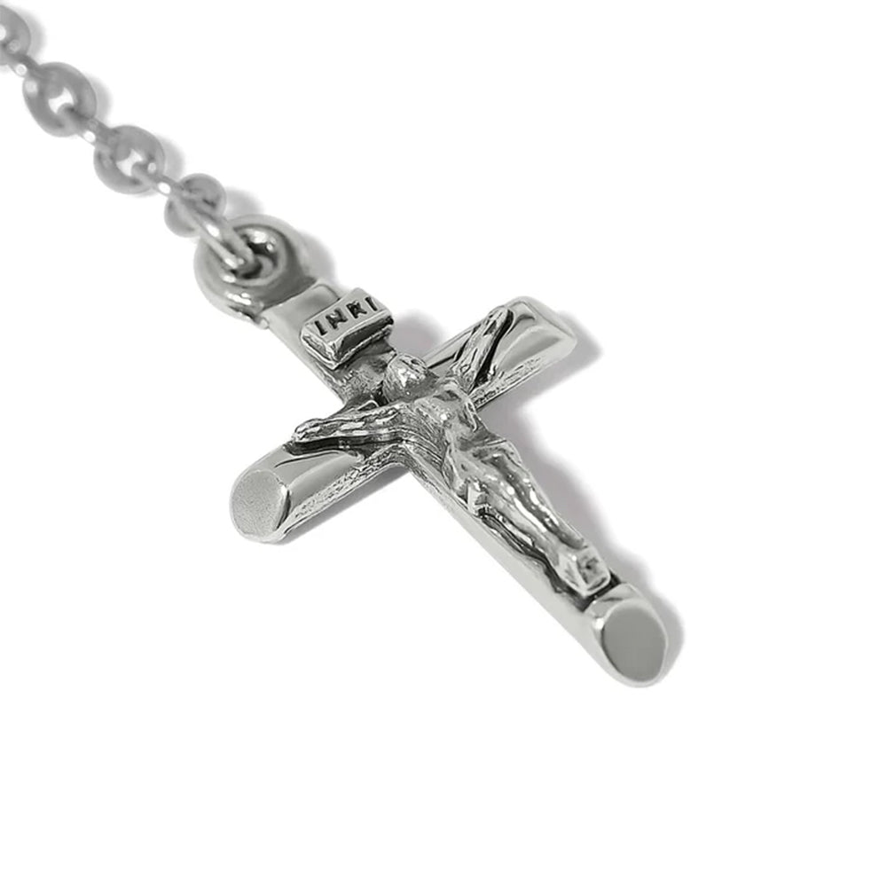 Silver crucifix pendant on a chain against a white background