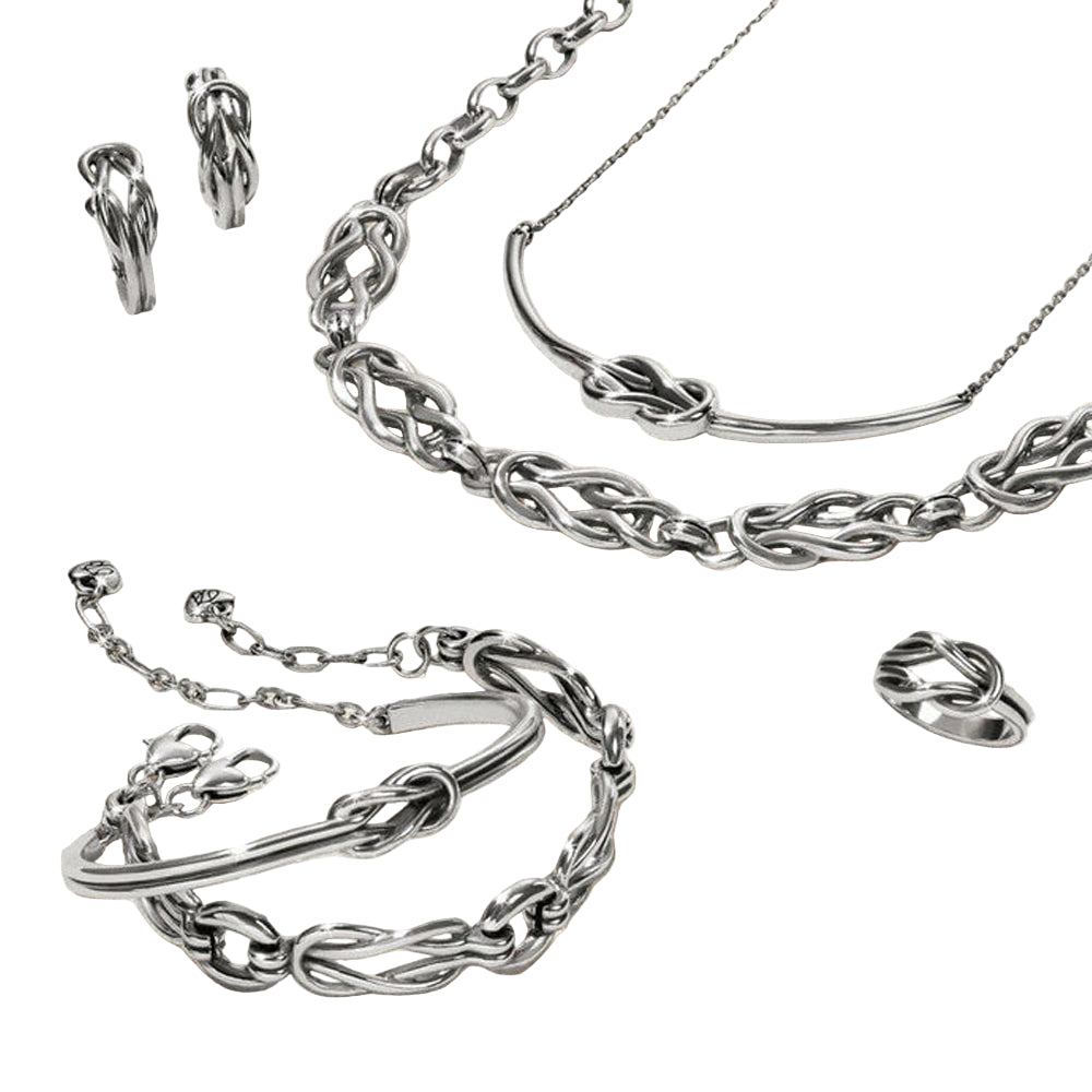 Silver jewelry set including necklace, bracelet, and earrings on a light background
