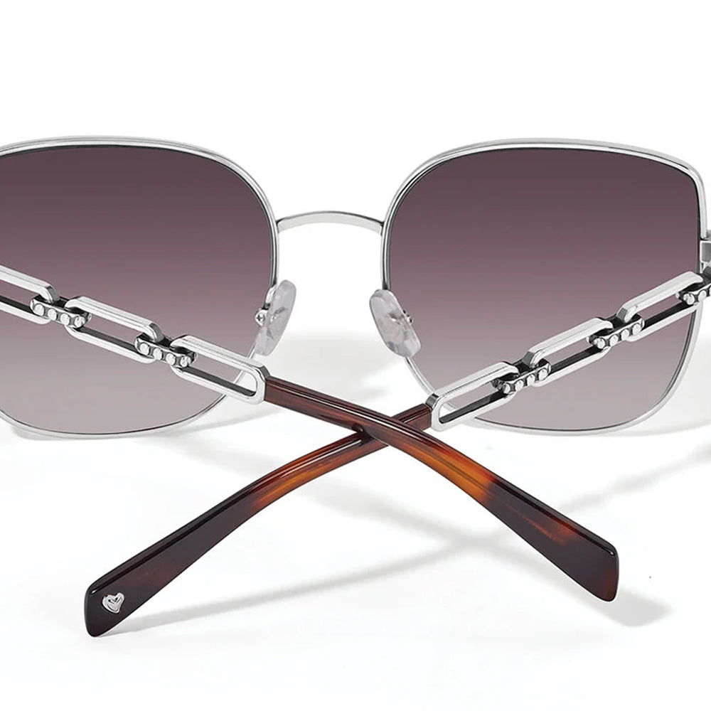 Sunglasses with gradient lenses and metallic frame on a white background