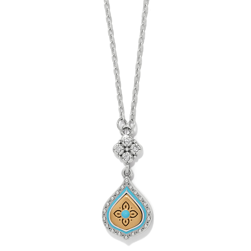 Necklace with a decorative pendant featuring a blue gemstone on a white background