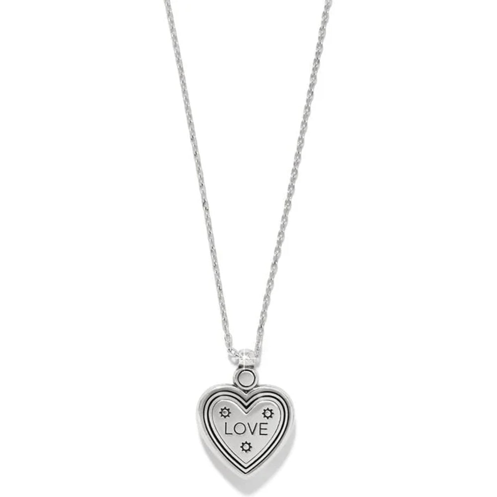 Heart-shaped pendant with 'LOVE' engraving on a chain against a white background