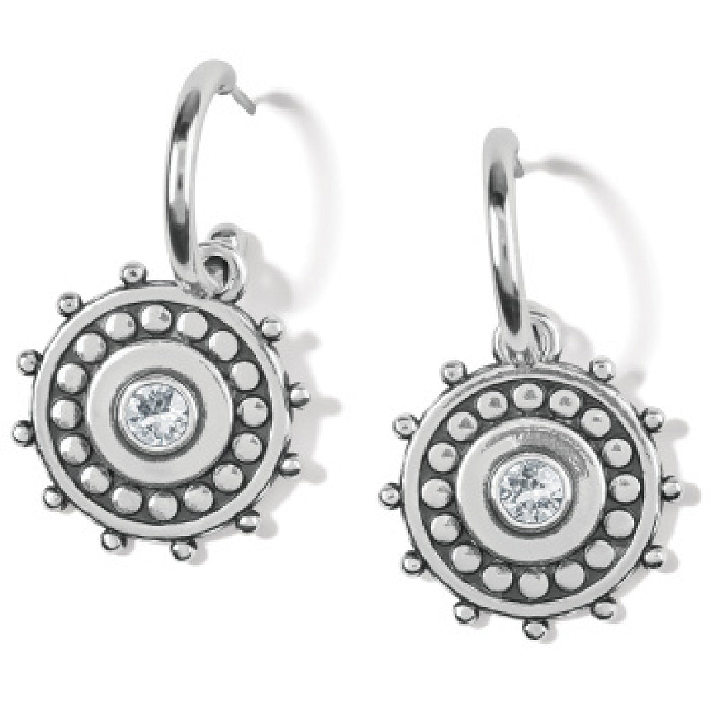 Silver earrings with circular design and clear gemstone on a white background