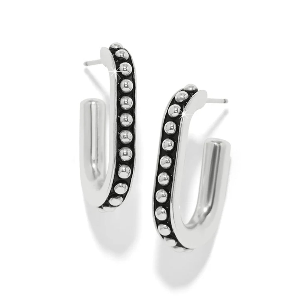 A pair of silver-toned hoop earrings with a curved front edge lined with small round clear stones, shown on a clean white background.