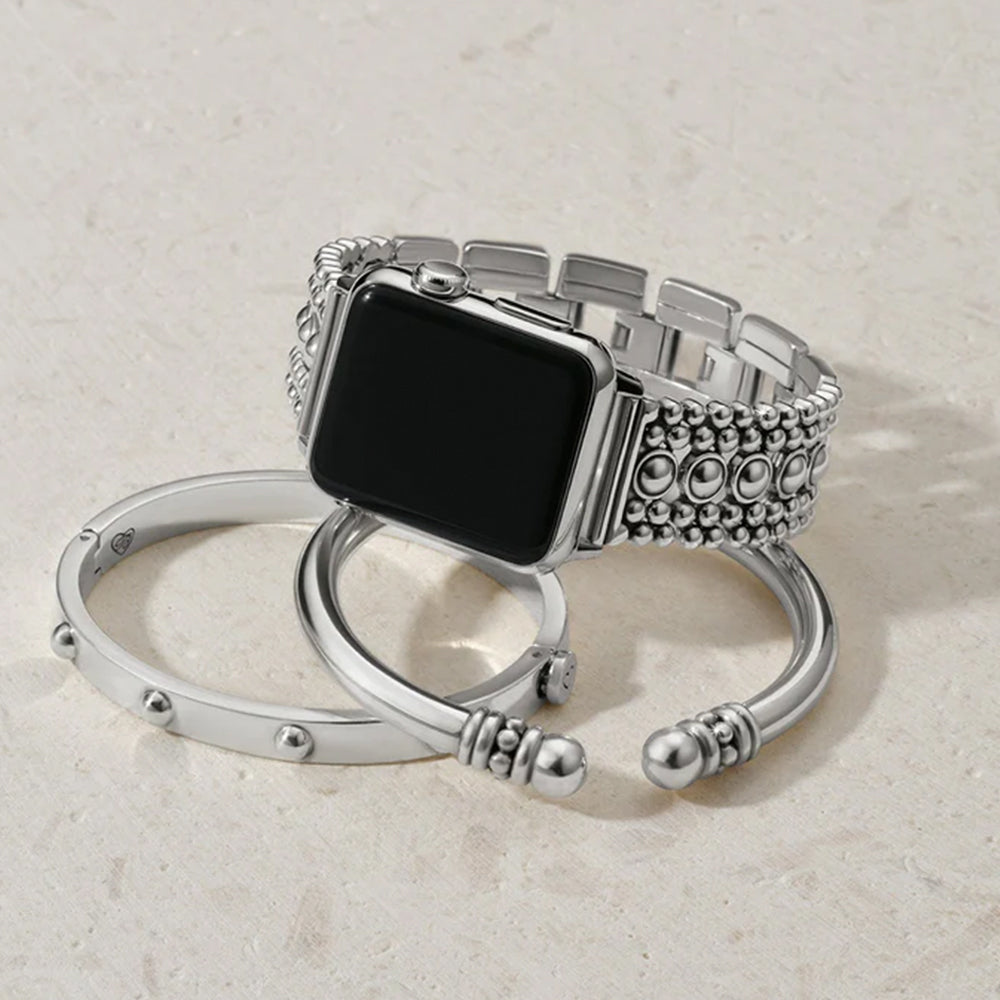 Silver watch band with intricate design on a light beige background