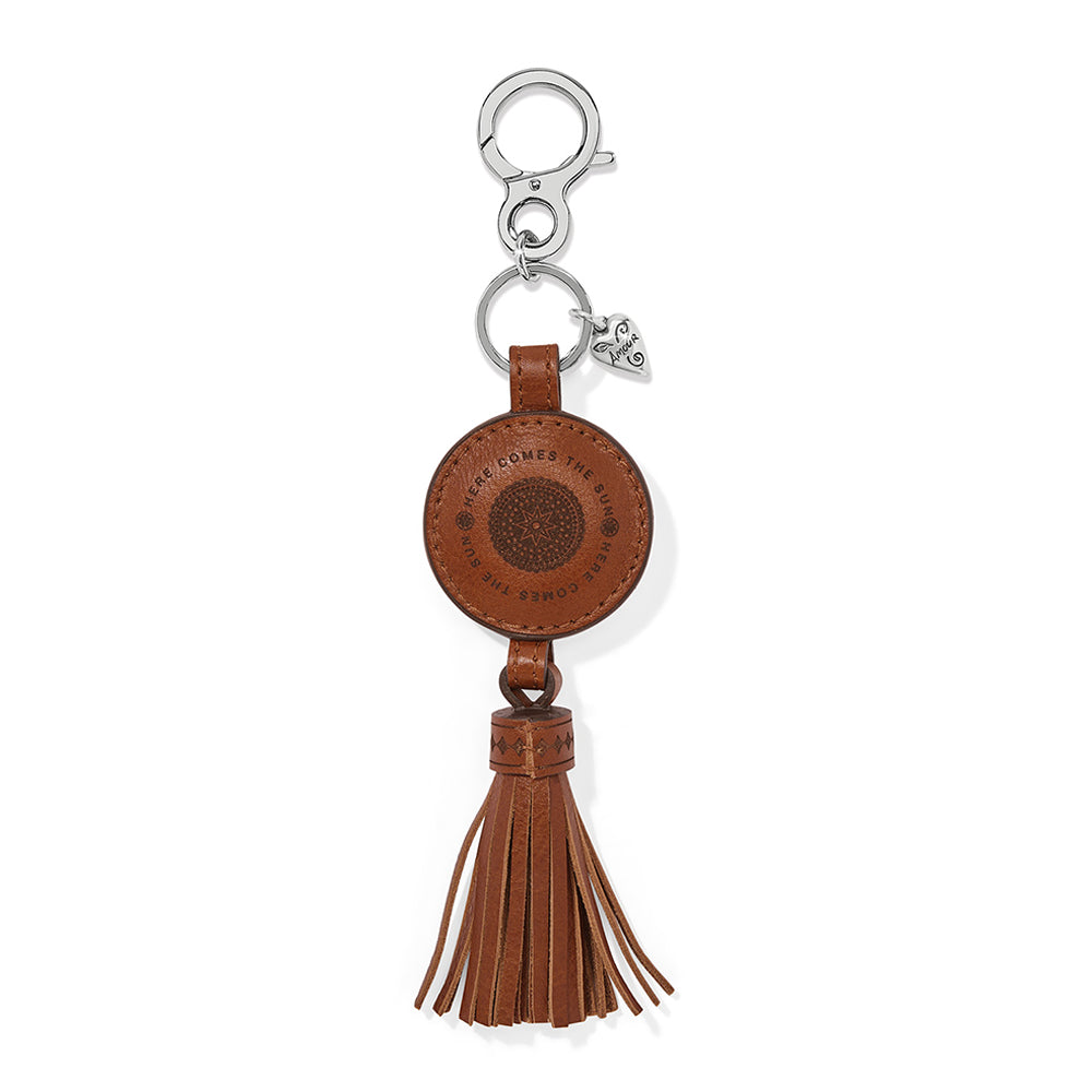 Brown leather keychain with tassel and silver clasp on a white background