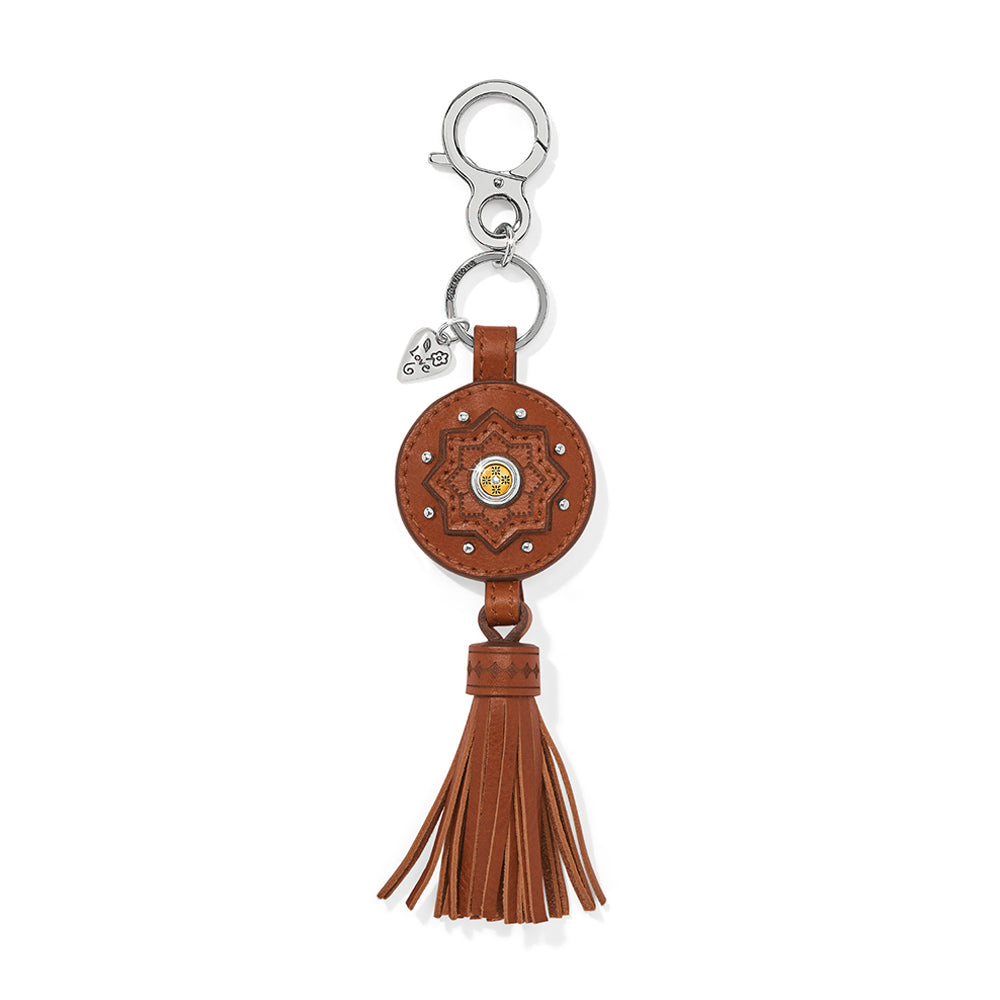 Brown leather keychain with tassel on a white background