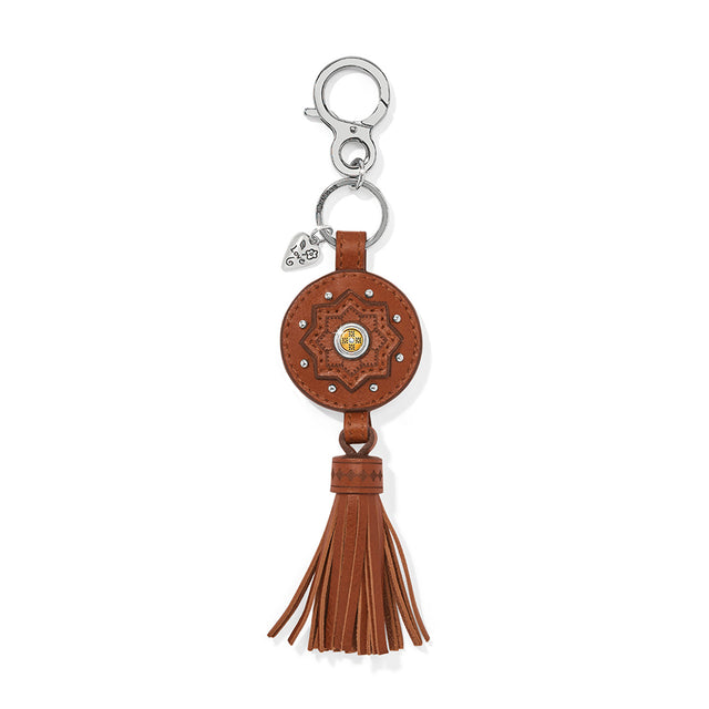 Brown leather keychain with tassel on a white background