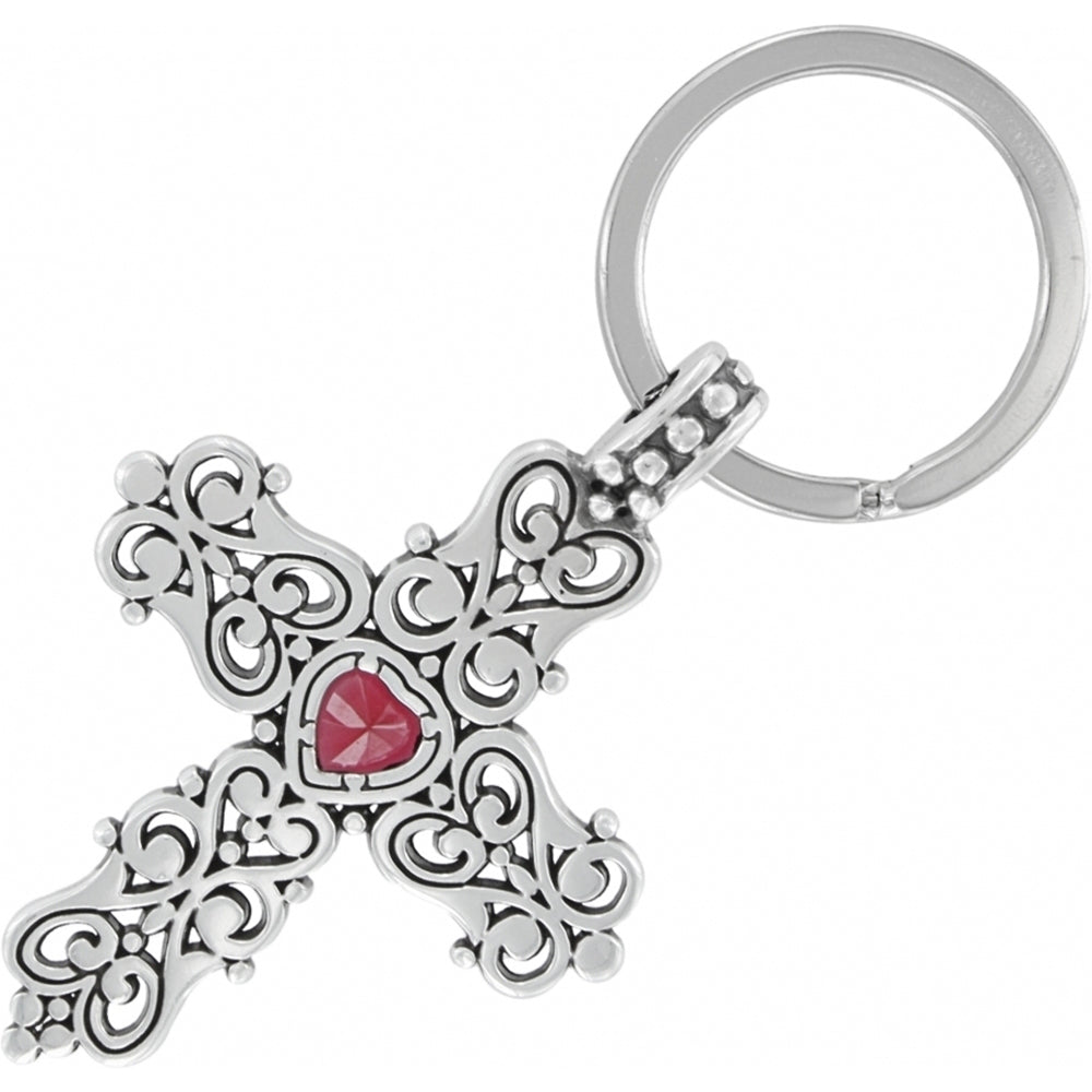 Silver cross keychain with a red gemstone on a white background