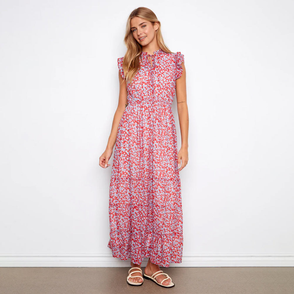 Woman wearing a red floral dress against a white background