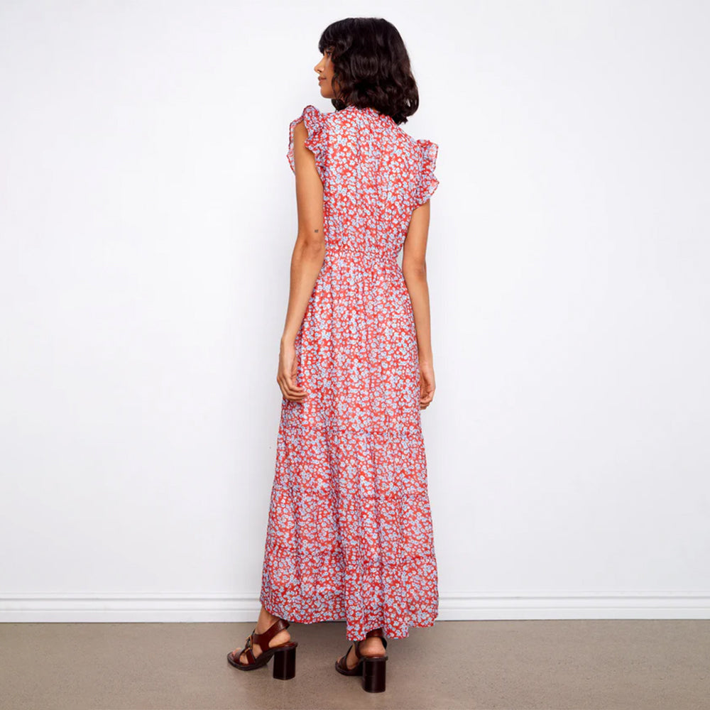 Woman wearing a red floral dress against a white background