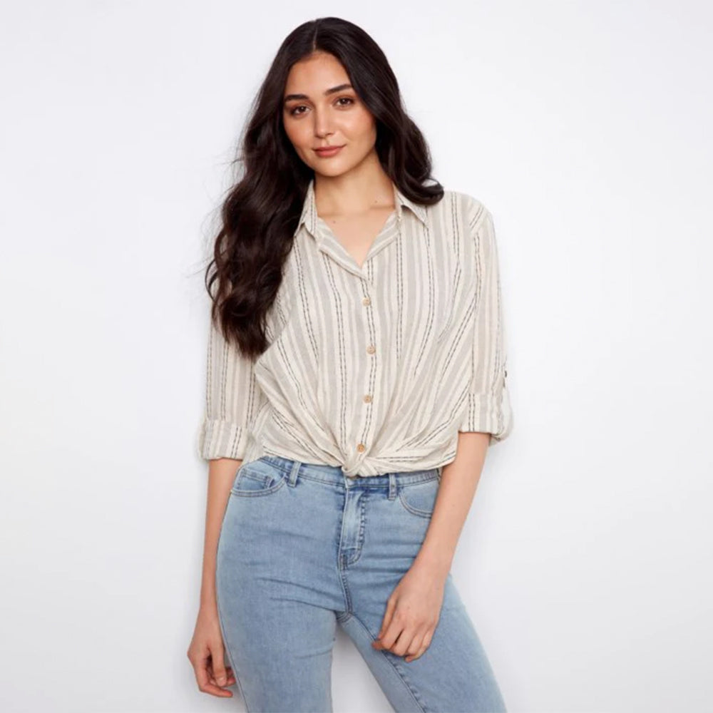 Woman wearing a striped shirt and jeans on a white background