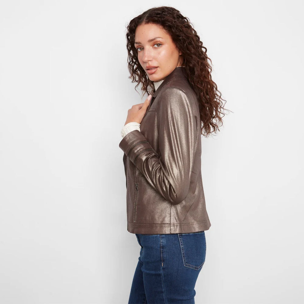 A woman with curly brown hair models a metallic bronze faux-leather jacket, paired with a white collared shirt and blue jeans, against a plain white studio background.