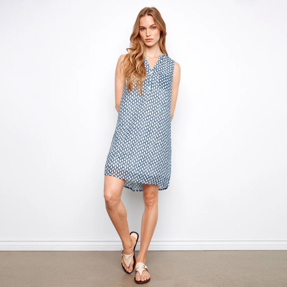 Woman wearing a blue patterned dress against a white background
