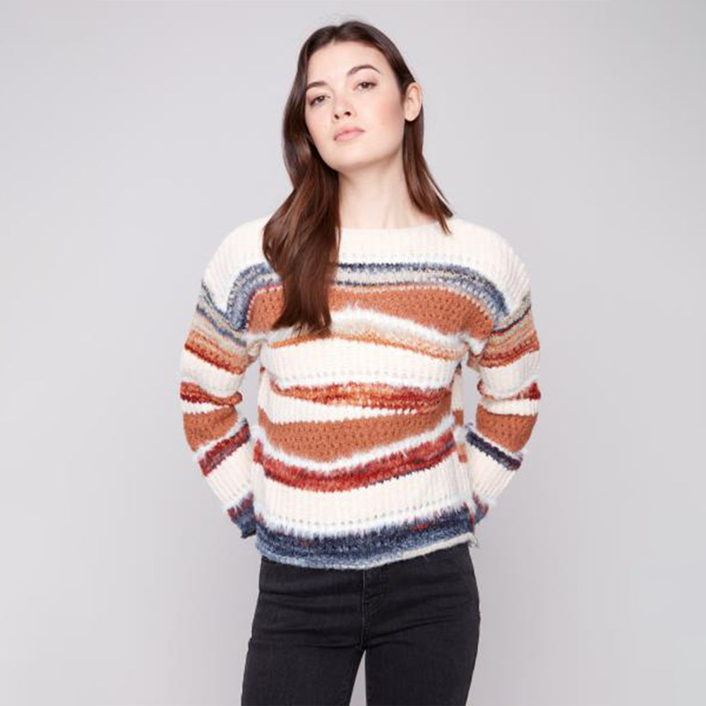 Woman wearing a striped sweater against a plain background