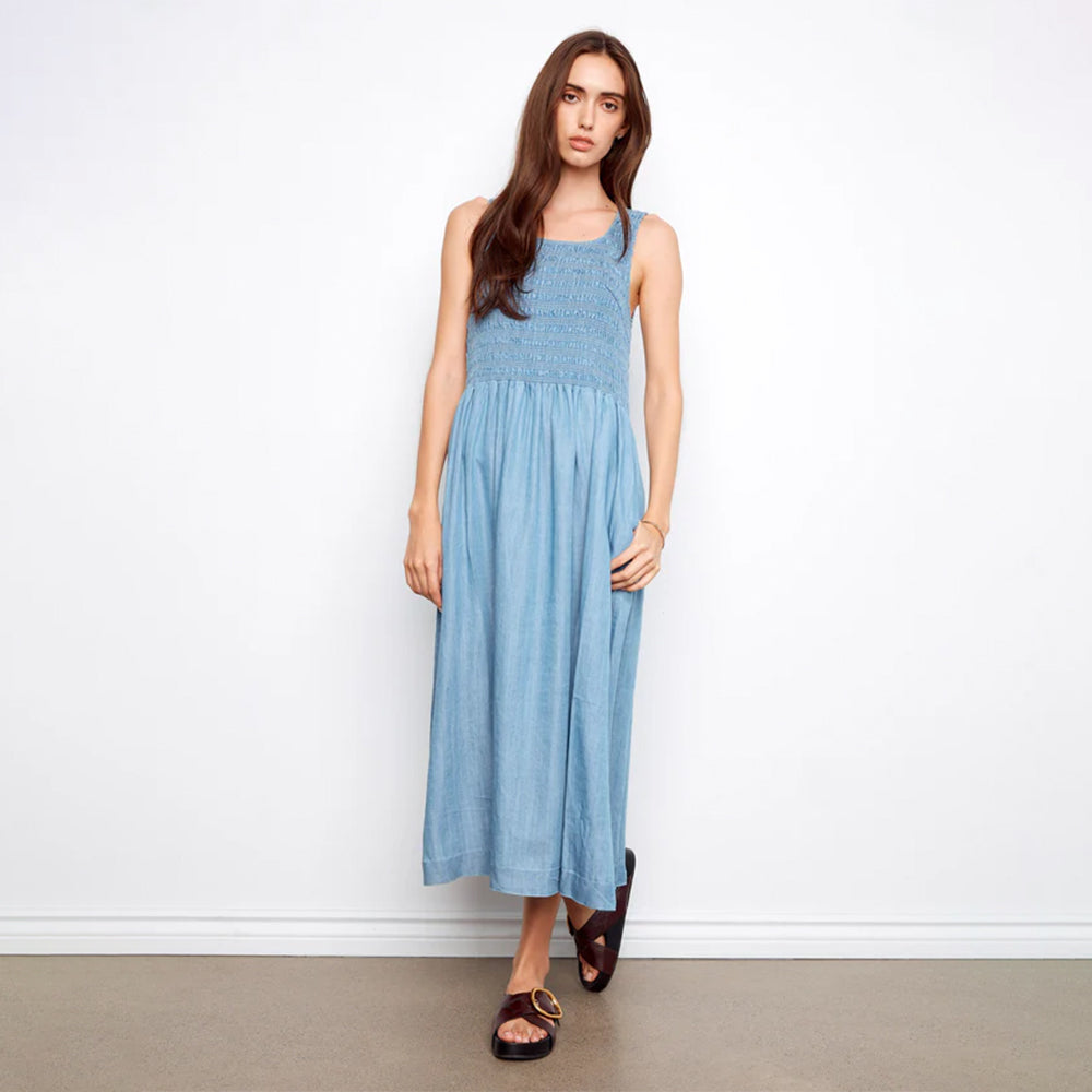 Woman wearing a blue dress against a white background
