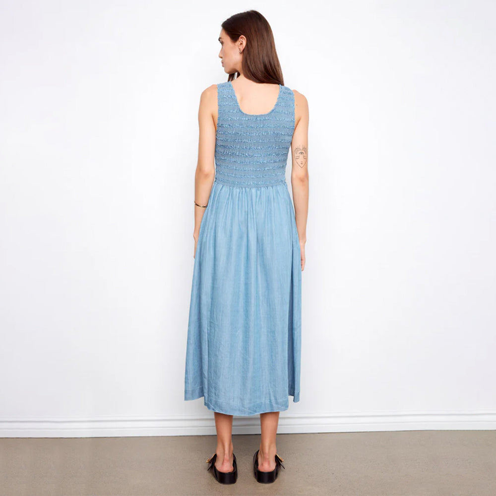 Woman wearing a light blue dress against a white background
