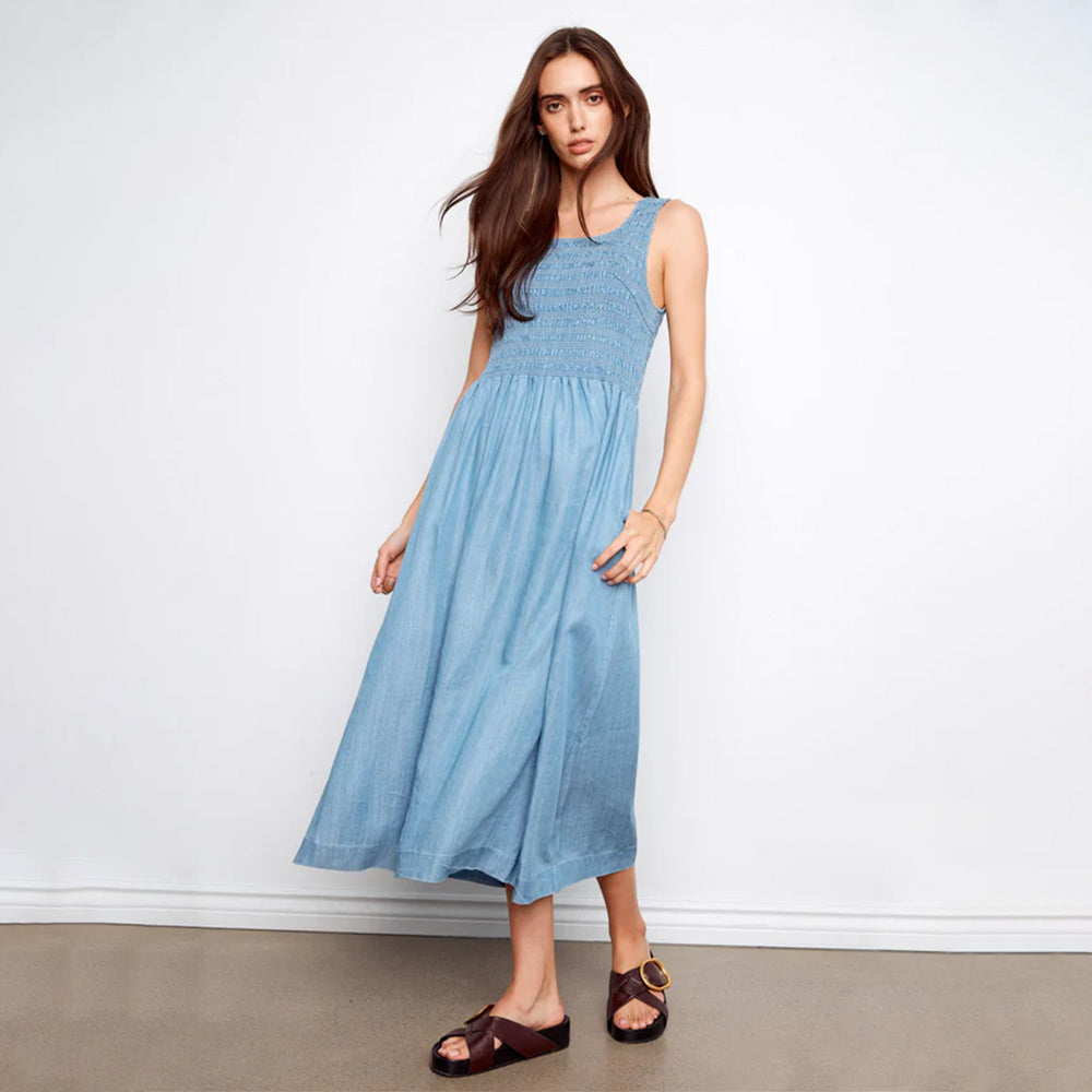 Woman wearing a blue dress against a white background