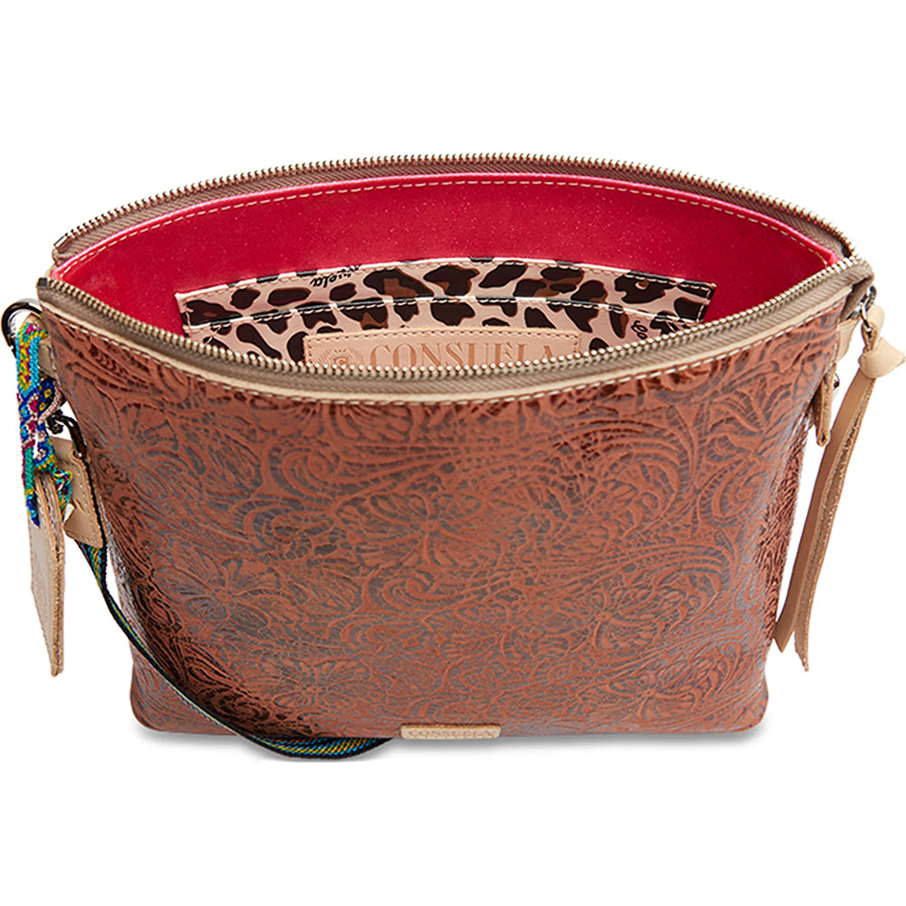 Brown patterned handbag with a leopard print pouch inside on a white background
