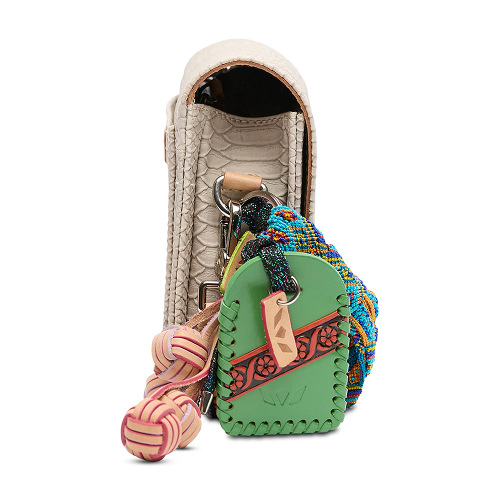 Crossbody with colorful rope and leather elements attached to a beige leather pouch on a white background