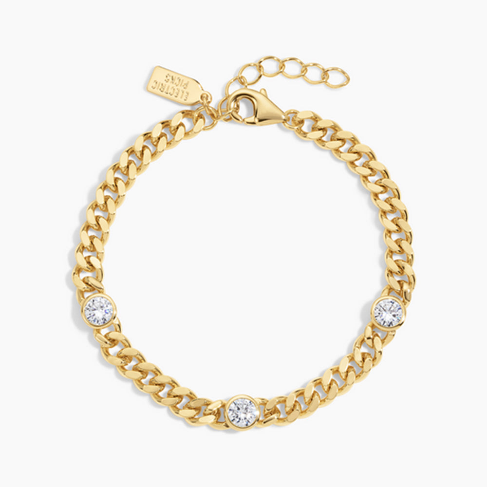 Gold chain bracelet with embedded crystals on a white background