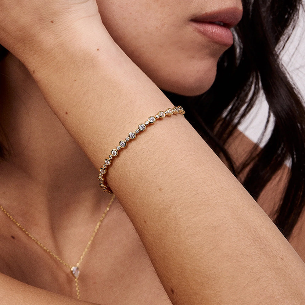 woman wearing gold bracelet