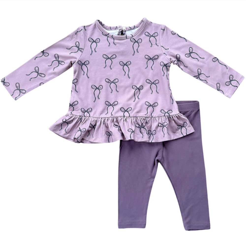 Purple children's outfit with bow pattern on a white background