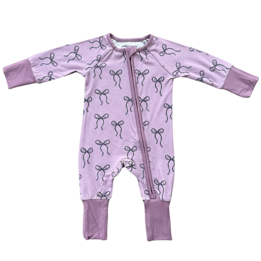 Purple baby onesie with bow pattern on a white background