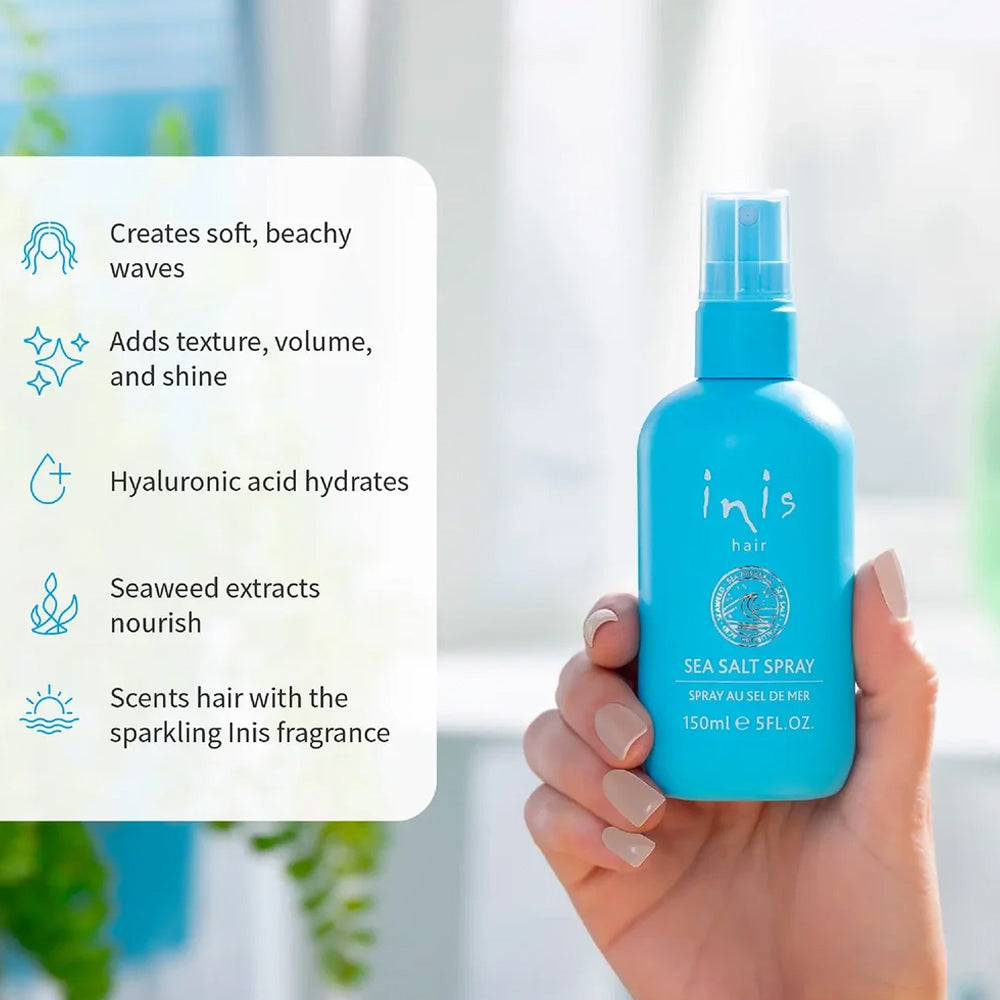 hand holding a lue bottle of Inis sea salt spray
