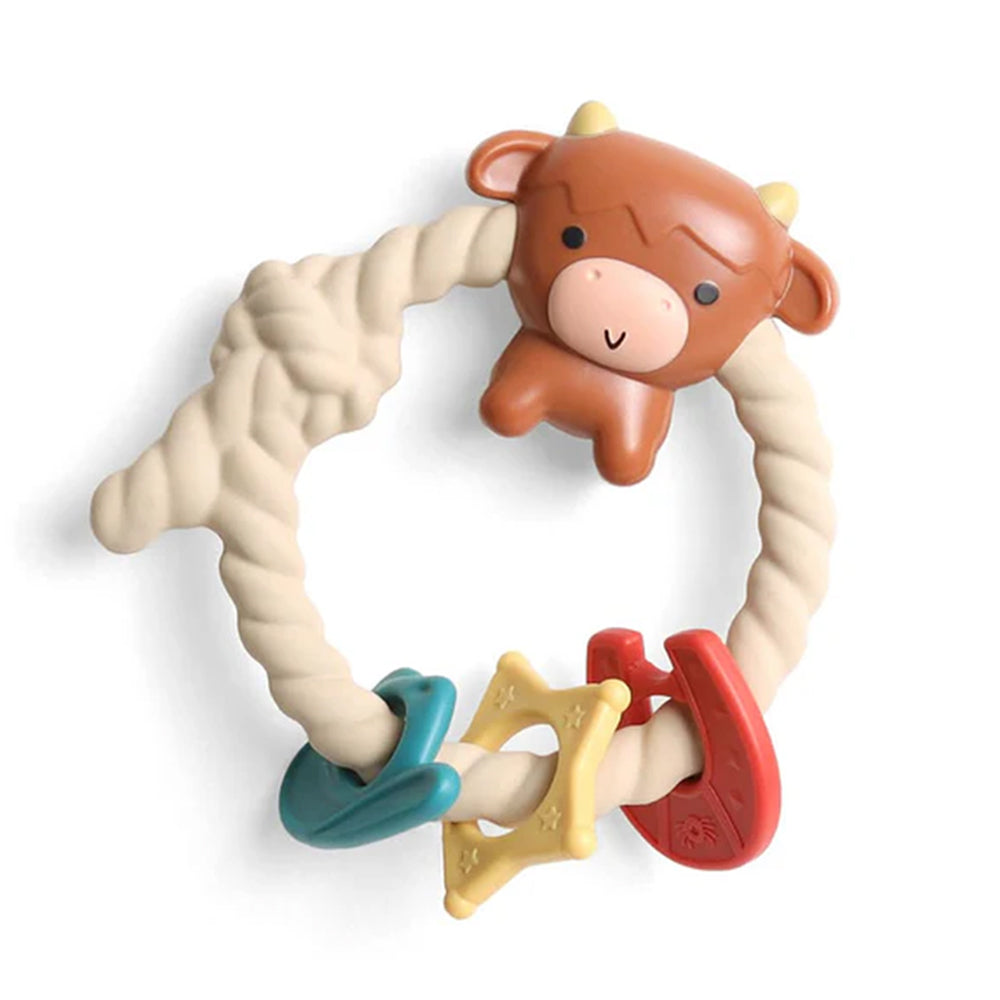 Teething ring with cow design and colorful teethers on a white background