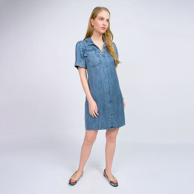 Woman wearing a denim dress on a white background
