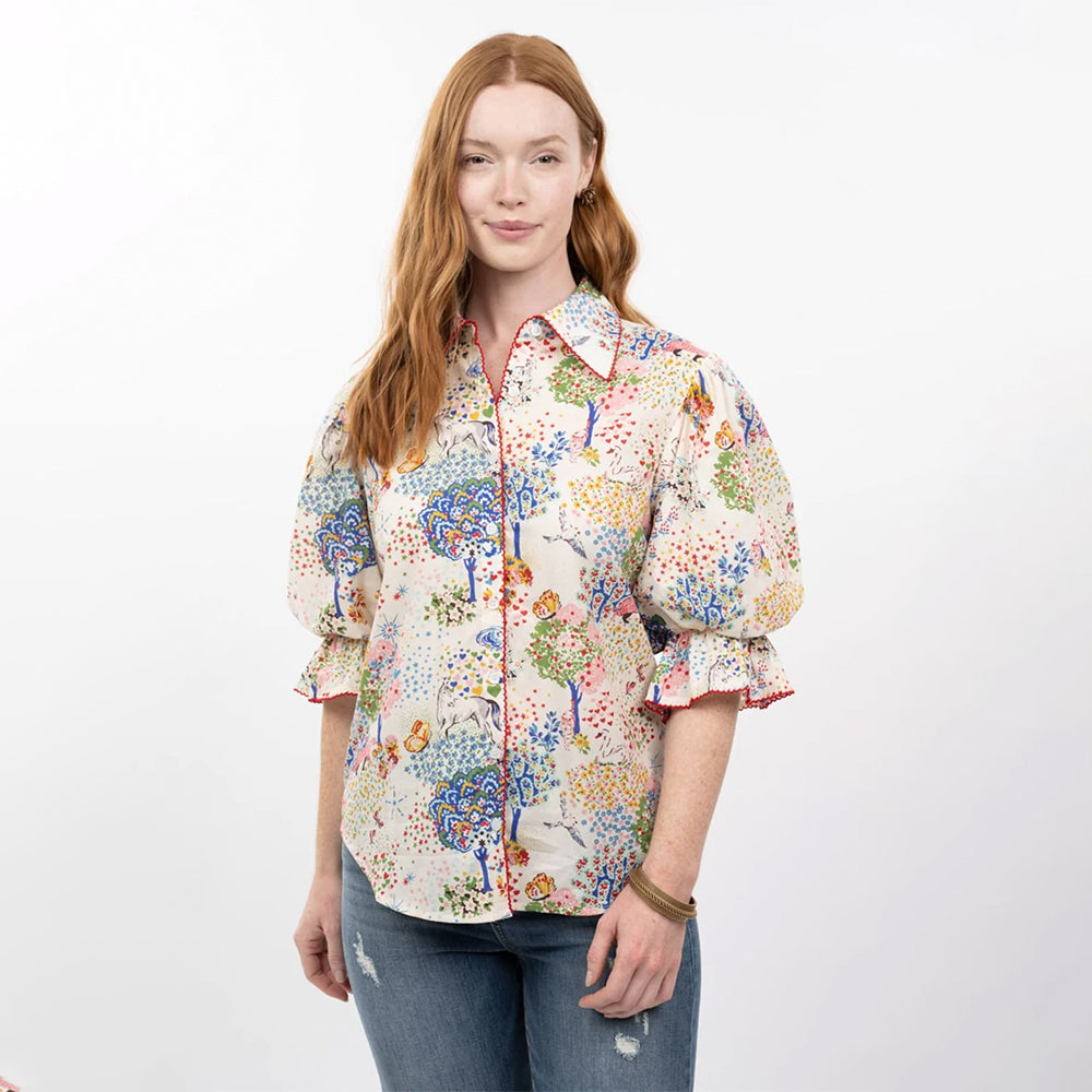 Woman wearing a colorful patterned shirt on a white background